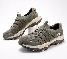 When you're ready to off-road while on foot, suit up and take the scenic route in these trail-hiking sneakers from Skechers. Exploring the great outdoors just got way more comfy with footwear designed with trekking in mind. Tread new trails or hike familiar paths (water bottle in tow!) in Stretch Fit mesh and cushioned memory-foam insoles. Plus, a suede upper keeps rugged comfort looking stylish too. From Skechers. Green Slip-on Walking Shoes For Outdoor, Cushioned Lace-up Walking Shoes For Outdoor Activities, Low-top Hiking Boots With Cushioned Footbed For Outdoor Activities, Outdoor Cushioned Slip-on Trail Running Shoes, Durable Slip-on Walking Shoes For Outdoor Activities, Sporty Slip-on Walking Shoes For Outdoor Activities, Outdoor Trail Running Shoes With Cushioned Footbed, Functional Slip-on Trail Running Shoes For Outdoor Activities, Functional Slip-on Trail Running Shoes For Outdoor