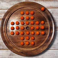 a wooden board with orange balls on it