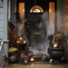 a front door decorated for halloween with candles and pumpkins