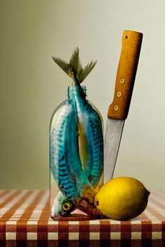 two fish in a bottle with a knife and lemon