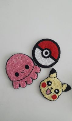 three patches with different designs on them, one has an octopus and the other has a pikachu