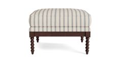 the foot stool is made from wood and has striped upholstered fabric on it