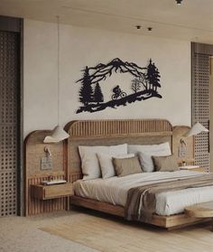 a bedroom with a large bed and wall decal