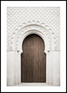 an image of a wooden door that is in the middle of a white stucco wall