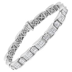 This geometric pattern link bracelet is a timeless piece. Small white gold bands inlaid with six princess cut diamonds link with larger bands inlaid with an additional twelve princess cut diamonds. 5 carat TDW in diamonds shine in this design. A box with clasp mechanism keeps the 14k white gold bracelet design secure. Bracelet has 252 natural, princess diamonds. Each stone weighs approximately 0.02 for a total weight of 5 carats. Each diamond is color rated G-H and clarity rated as SI1-SI2. "Video Available Upon Request" Gold Bracelet Design, Gold Link Bracelet, White Gold Bracelet, Circle Diamond, Bracelet Design, Princess Diamond, White Gold Band, Tennis Bracelet Diamond, Princess Cut Diamonds