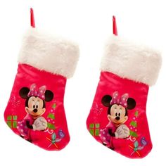 two christmas stockings with minnie mouse on them, one is pink and the other is white