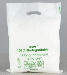 a white bag with green writing on the front and bottom that says, pure 100 % biodegradable a bag that returns to nature