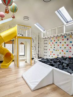 a room with a slide and climbing wall