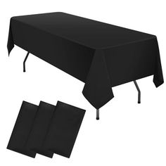 a black tablecloth with four place mats on it and three napkins underneath the table