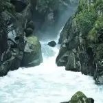 the water is rushing down the rocks in the river