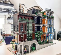 a building made out of legos sitting on top of a table in a room