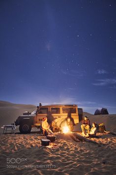 people sitting around a campfire in the desert