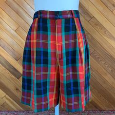 These adorable plaid shorts can be worn dressed up or down. Would be a great Christmas look with some tights.  Excellent condition.  By Rafaella Measurements taken while flat: Waist: 28" Hips: 40" Inseam:  7" Rise: 13" Fitted Plaid Shorts, Retro Plaid Short-length Bottoms, Fitted Plaid High-waisted Shorts, Plaid High-waisted Fitted Shorts, Retro Plaid Short Bottoms, Preppy Plaid Short Bottoms, Suit Shorts, Christmas Look, Plaid Suit