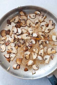 mushrooms are cooking in a pan on the stove