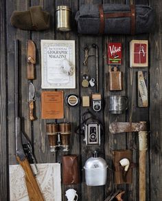 an assortment of items are displayed on a wooden surface, including hats and other things