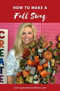 a woman standing in front of a pink wall holding a fall wreath with the words how to make a fall swag