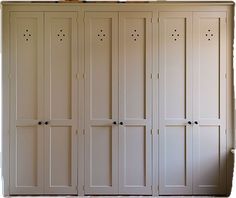 an empty room with several white cupboards