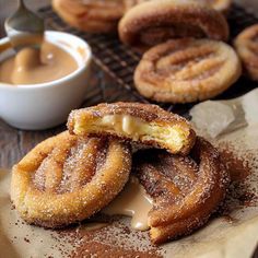 some sugared doughnuts are sitting on a table