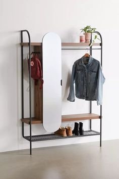 a coat rack with shoes and jacket hanging on it