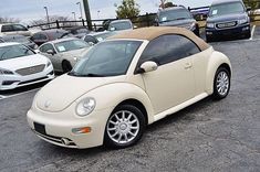 a white car parked in a parking lot next to other cars