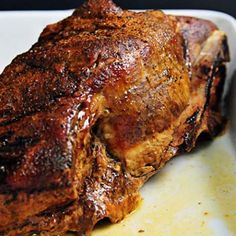 a piece of meat sitting on top of a white plate