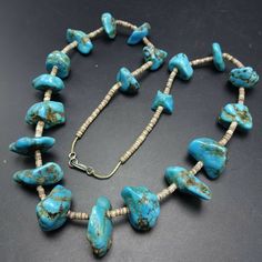 "VINTAGE NAVAJO TURQUOISE NECKLACE DESCRIPTION: This strand features hand formed beads of blue Kingman turquoise, spaced and finished with fine hand rolled shell heishi. PLEASE NOTE: One of the turquoise beads is chipped, it is at the end of the strand (see photos). This gorgeous necklace will be a valuable addition to your collection of fine vintage Native American jewelry. MEASUREMENTS: Necklace measures 25\" end to end Beads are securely strung on natural fiber WEIGHT: 104.9 grams SIGNED: no Vintage Blue Oval Bead Necklace, Vintage Blue Necklaces With Oval Beads, Vintage Blue Necklace With Oval Beads, Vintage Turquoise Single Strand Necklace, Vintage Beaded Turquoise Necklace With Round Beads, Vintage Adjustable Turquoise Beaded Necklace, Adjustable Vintage Turquoise Beaded Necklace, Vintage Turquoise Necklace With Polished Beads, Vintage Adjustable Turquoise Beaded Necklaces