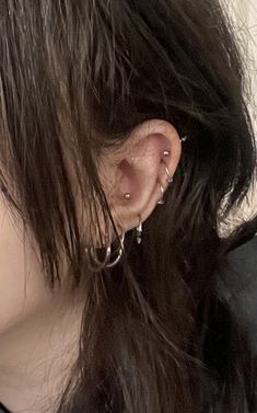 a close up of a person with ear piercings