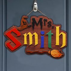 a wooden sign that says mr and mrs smith on it's front door hanging from a hook