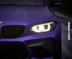 the front end of a purple bmw car