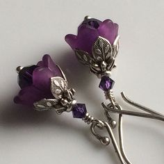 "Adorable and sweettiny amethyst tulips from my \"Bouquet of Flowers\" collection These precious little tulips are designed from dark amethyst colored Swarovski crystals capped with beautiful acrylic tulips. Layers of ornate leafy beadcaps in antique sterling silver plate add that perfect touch of detail. These diminutive drops hang a mere 5/8\" (14mm) from oxidized sterling silver French earwires. Prefer a different style of earwires? Non pierced clips in antique silver plate, leverbacks and ki Elegant Lavender Flower Earrings For Gift, Elegant Purple Sterling Silver Flower Earrings, Elegant Purple Earrings For Gift, Elegant Purple Flower Earrings, Elegant Purple Flower Shaped Earrings, Purple Flower Earrings With Ear Wire As Gift, Purple Flower Earrings With Ear Wire For Gift, Elegant Lavender Earrings With Ear Wire, Purple Pierced Earrings For Wedding