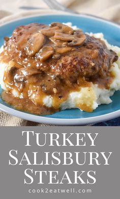 a blue plate topped with mashed potatoes covered in gravy