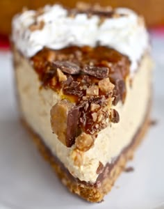 a piece of cake on a plate with whipped cream and pecans in the middle