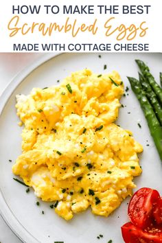 scrambled eggs on a white plate with asparagus and tomatoes in the background text reads how to make the best scrambled eggs made with cottage cheese