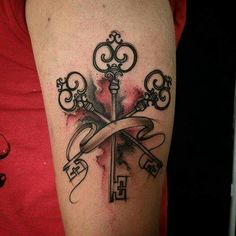 a woman with a tattoo on her arm has a cross and keys wrapped around it