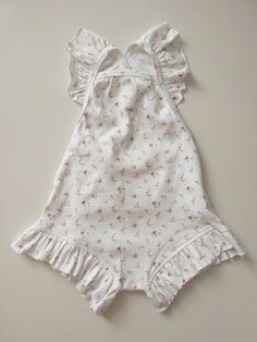 My Niayah Lace  Listing includes - 1 playsuit  Floral - sweet floral Base colour - ivory  Style - Tie up Frill shoulders and legs  Size- True to size  6 months  1 year 2 year 3 year If bubs it longer bodied always size up  Absolutely so gorgeous in a mini ditsy floral pattern customised and printed by My Niayah Lace Fabric  96% cotton  4% Spandex Stretchy breathable comfortable quality Sweet White Bubble Romper With Ruffles, Cute Cream Bubble Romper With Ruffles, White Flutter Sleeve Bubble Romper For Spring, White Cotton Jumpsuits And Rompers With Floral Print, White Sweet Bubble Romper For Spring, Sweet White Bubble Romper For Spring, White Floral Print Bubble Romper For Playtime, Cotton Bubble Romper For Spring Garden Party, Spring White Ruffled Onesie