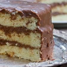 two slices of cake on a plate with one slice cut out and the other half eaten