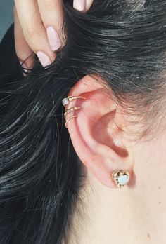 a close up of a person's ear with two different types of piercings