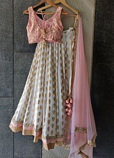 Elevate your occasional wear with this exquisite Ivory Embroidered Georgette Lehenga set, crafted from premium georgette fabric. The flowing ivory lehenga is adorned with shimmering pearl sequin detailing and a luxurious gold ruffle border, exuding elegance with every step. Paired with a powder pink silk blouse featuring intricate zari embroidery, the look is further enhanced with a soft pink dupatta. This dupatta, highlighted with subtle sequins and finished with a stunning gold scallop border, Lengha Choli, Pink Lehenga, Indian Wedding Wear