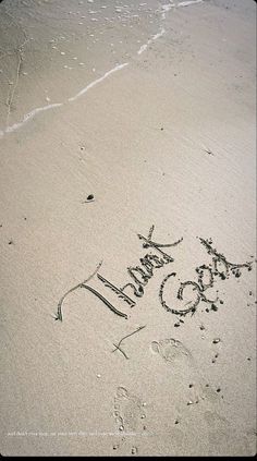 thank god written in the sand at the beach