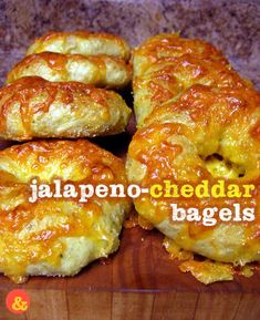 there are several cheesy bagels on the wooden board with words in spanish