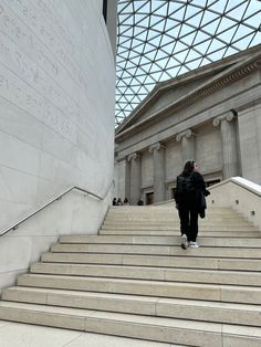 a person walking up some steps in front of a building