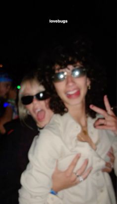 two women in sunglasses are posing for the camera