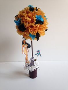 there is a vase with flowers in it and an image of a woman on the top