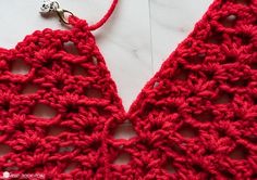 the crocheted triangle is being worked on