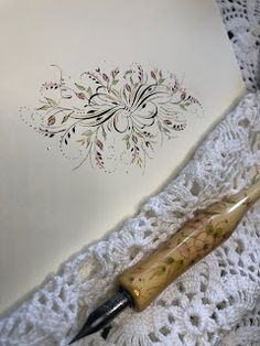 a pen sitting on top of a white doily