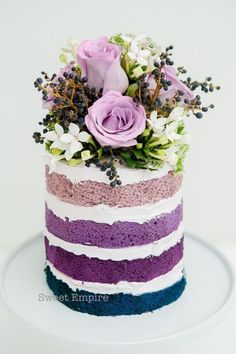 a multi - colored cake with flowers on top