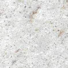 a white marble counter top with brown spots