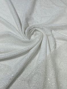 a white fabric with small dots on the top and bottom, as well as some other material