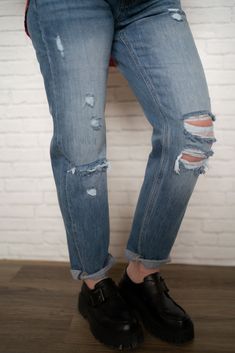 The ultimate jeans for spring! Mid rise classic Boyfriend style 100% cotton Distressing around knees Open side seam Double fold hem Model is 5'0" and wearing a size. The length measures 37" and the inseam measures 28". Everyday Dark Wash Jeans With Frayed Hem, Dark Wash Mom Fit Jeans For Spring, Spring Dark Wash Mom Fit Jeans, Distressed Denim Blue Jeans For Everyday, Washed Cropped Jeans For Everyday Fall Wear, Everyday Distressed Denim Blue Jeans, Fall Cropped Washed Jeans For Everyday, Everyday Washed Cropped Jeans For Fall, Casual Washed Cropped Jeans For Fall