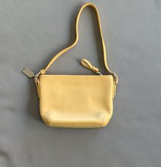 ~Ships same business day when possible~ Selling an authentic, pre-owned Coach mini leather handbag in "camel" or light-yellow. Strap is a convertible by design - can be unbuckled, doubled up and re-attached for a shorter handheld length. Bag shows some signs of staining and usage as pictured.  Bag measures approximately 8 inches wide across the top, and 5 inches tall. Please reach out if you have any questions. Thanks for looking! Yellow Purse, Yellow Purses, Small Leather Bag, Handbag Purse, Light Yellow, Leather Handbag, Leather Handbags, Convertible, Bags Handbags